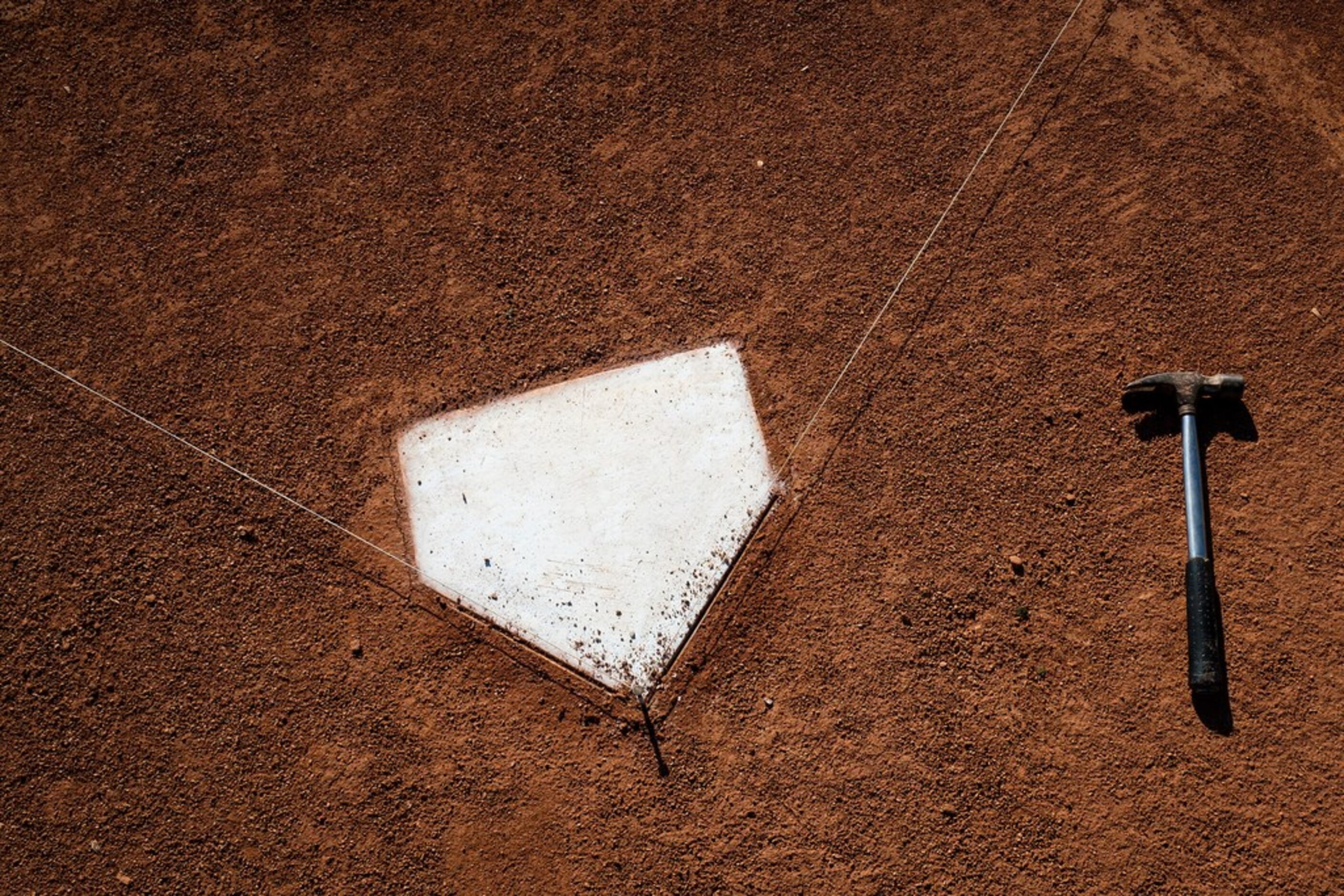 A groundskeeper's tools rest near home plate on a practice field on the day Texas Rangers...