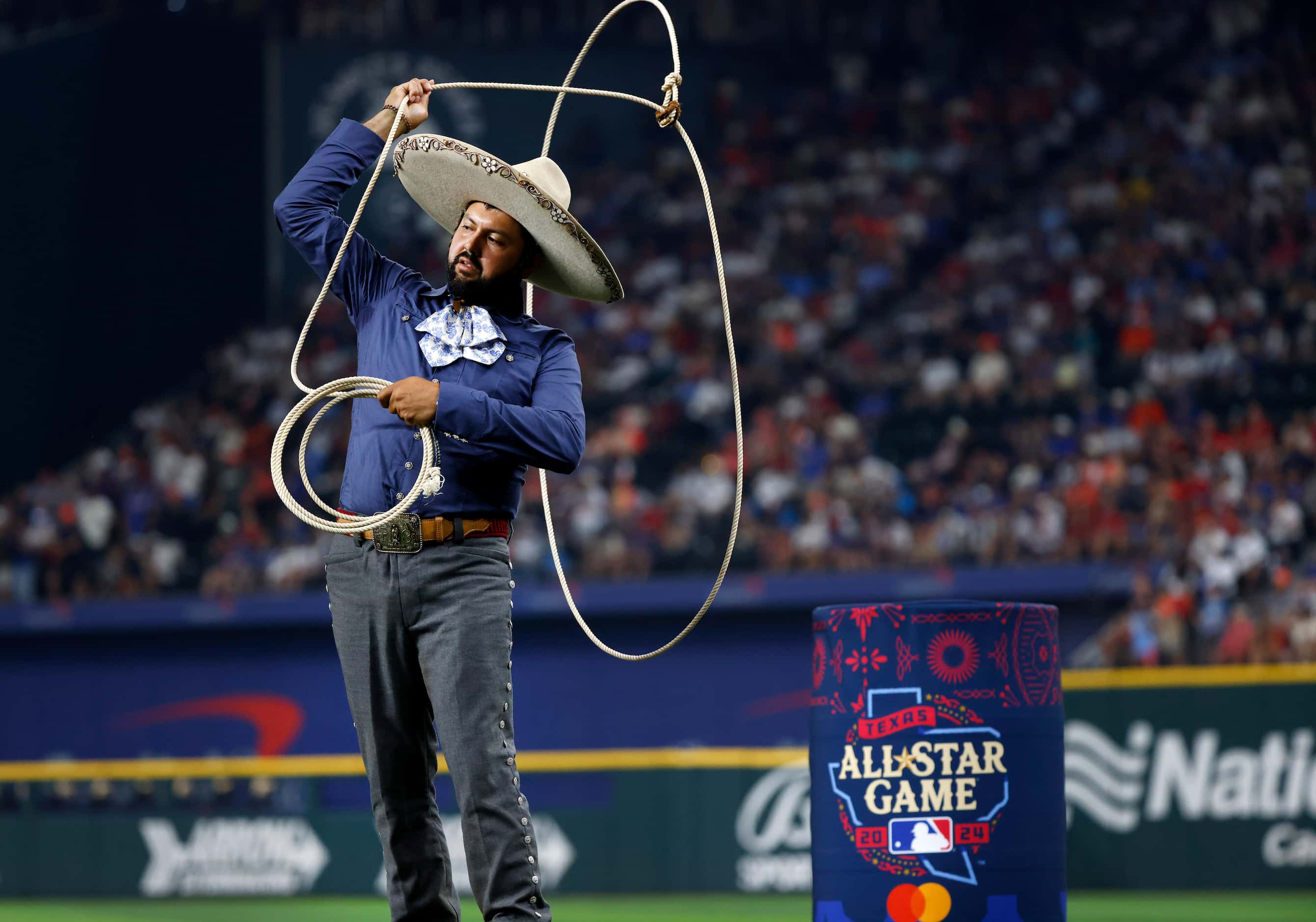 A vaquero performs roping tricks as the American League players are introduced during the...