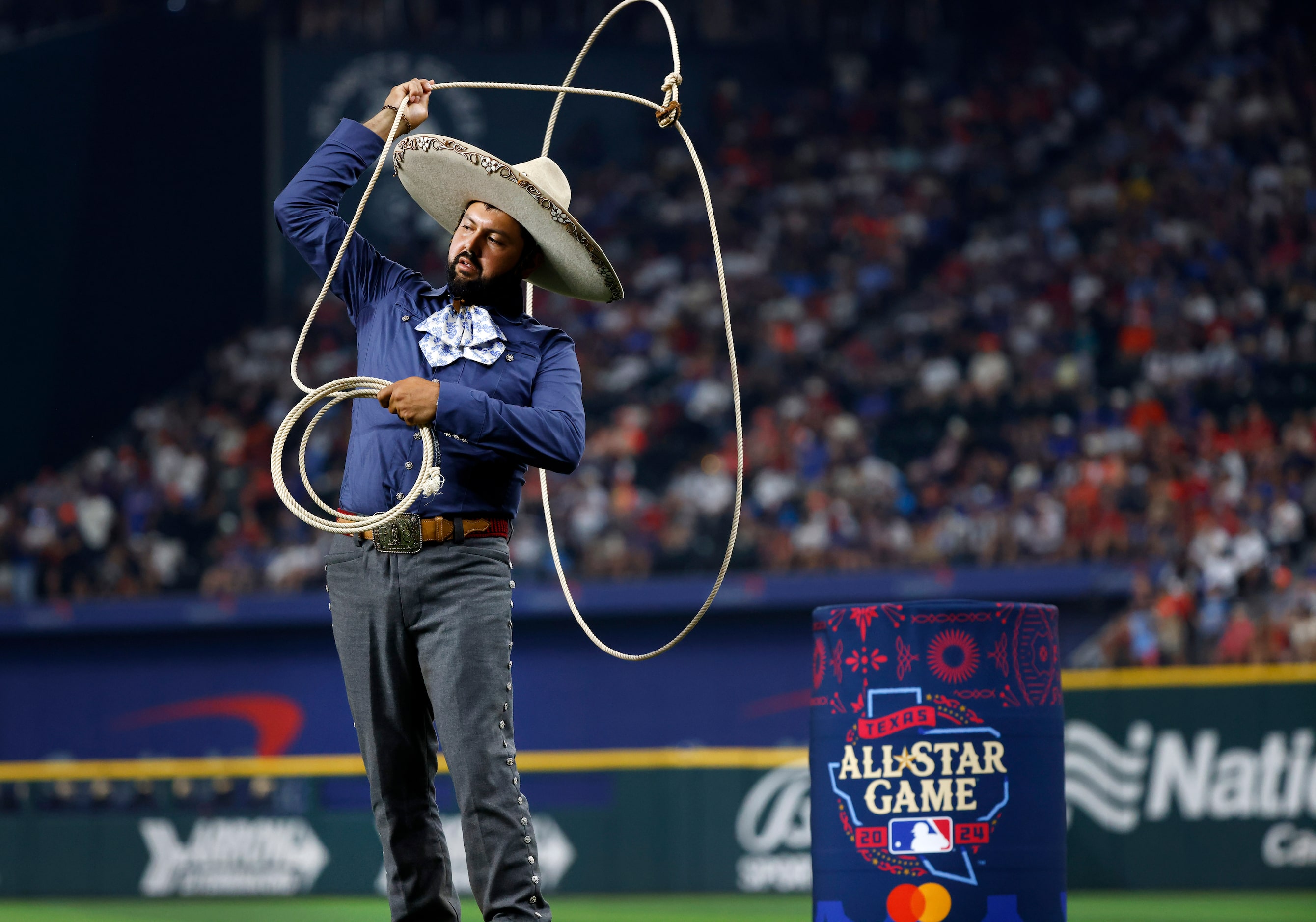 A charro performs roping tricks as the American League players are introduced during the MLB...