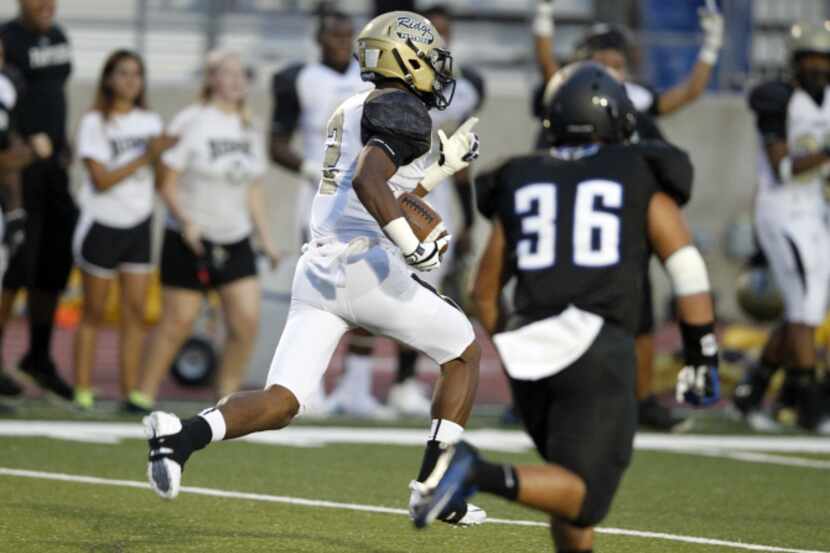 Keller Fossil Ridge's Ryan Parker (2) runs away with the ball for a touchdown off a kickoff...