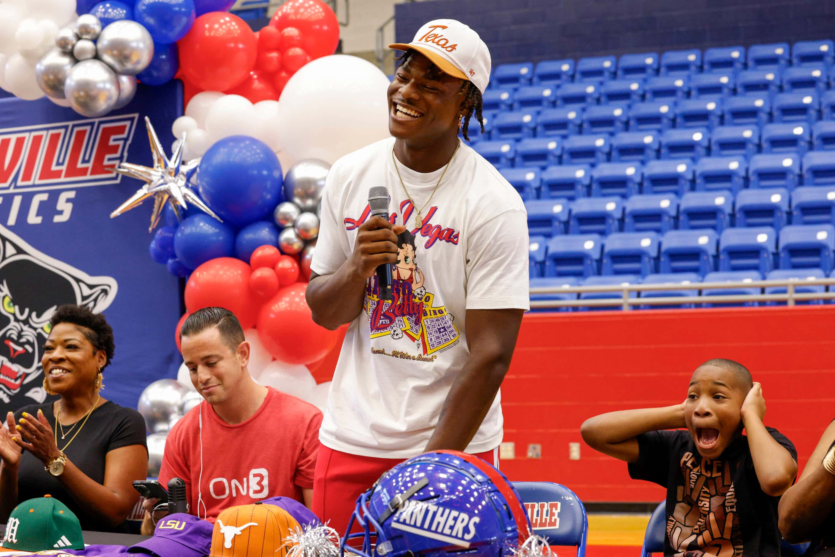 Duncanville defensive lineman Colin Simmons stands as he announces he will be attending the...