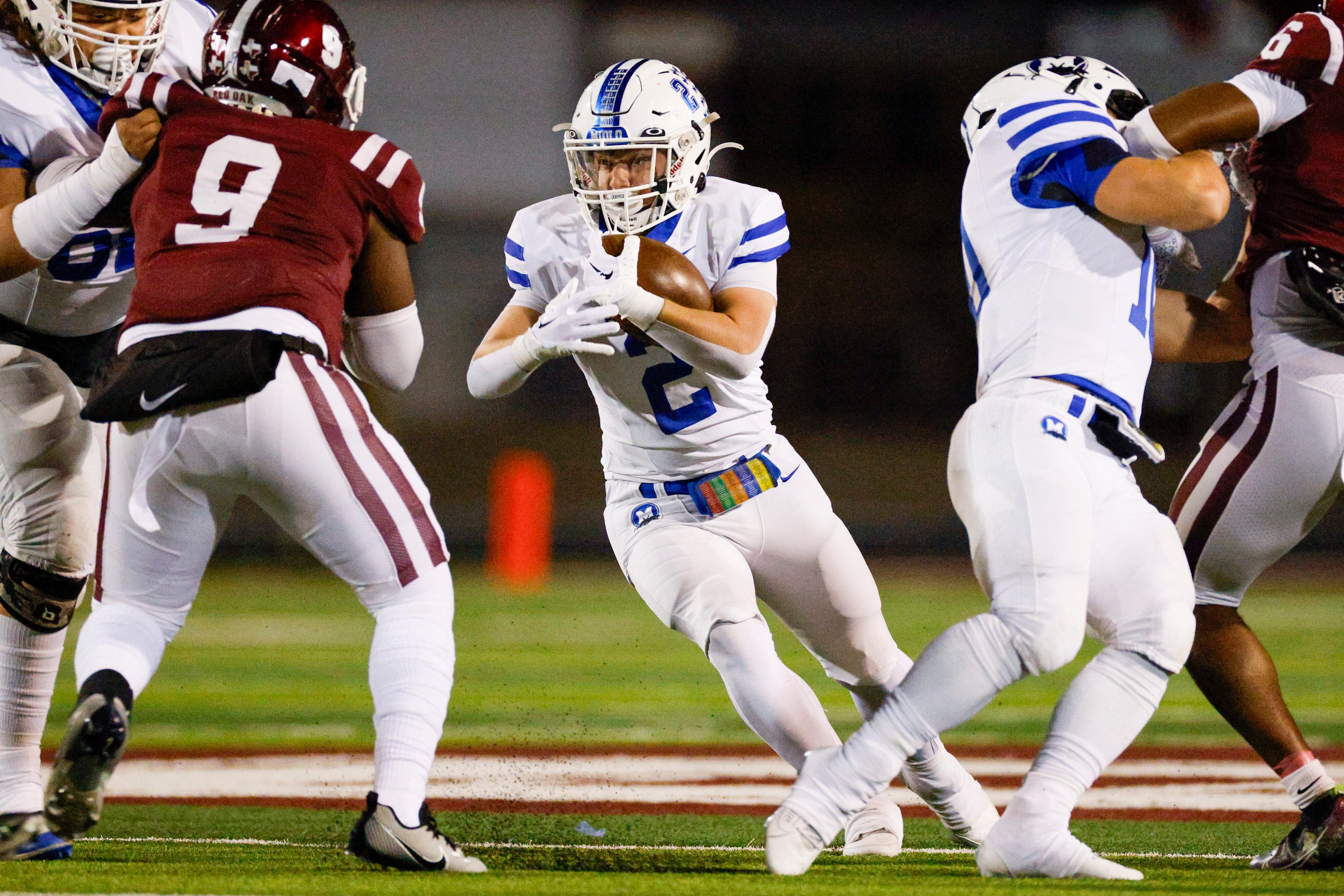 Midlothian running back Slater Callahan (2) runs the ball through the line of scrimmage...