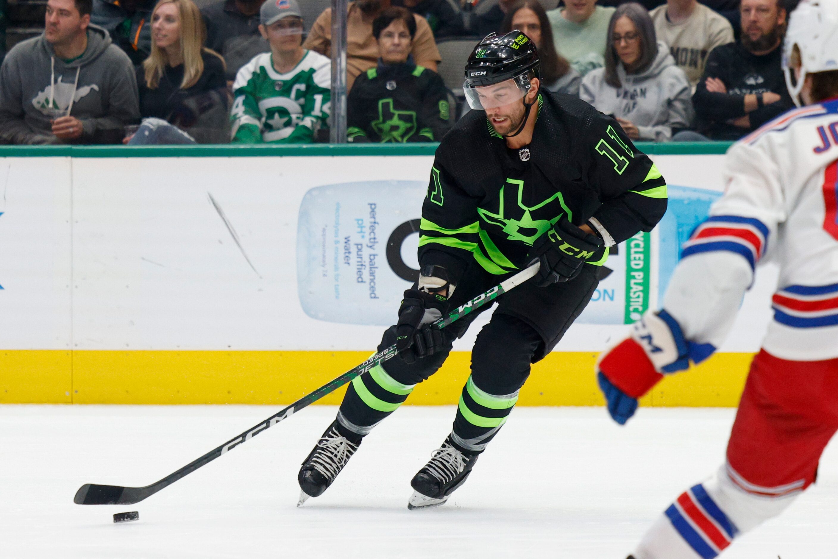 Dallas Stars center Luke Glendening (11) skates with the puck as New York Rangers defenseman...