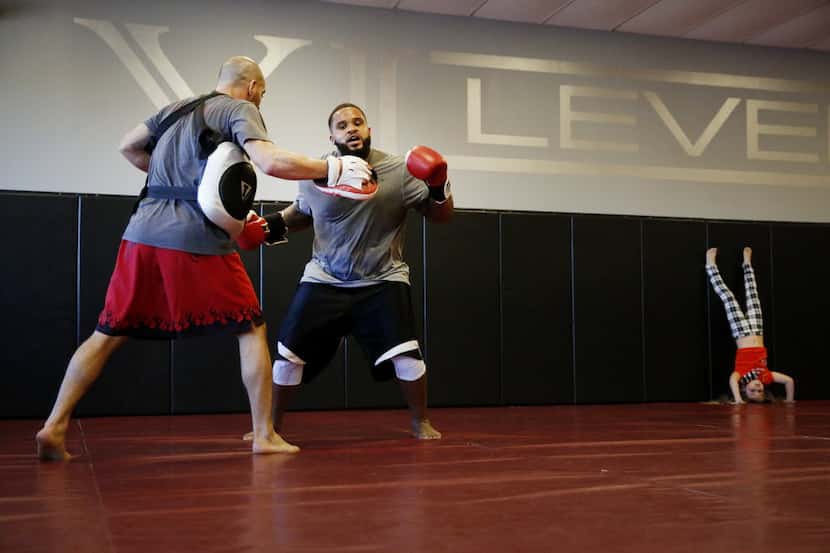 Texas Rangers first baseman Prince Fielder (right) spars with trainer Ryan Keenan during a...