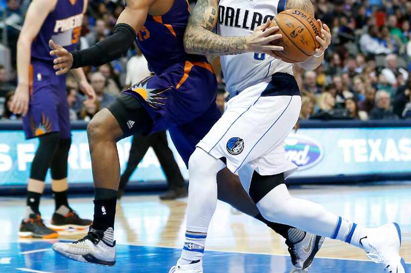 Dallas Mavericks guard Deron Williams (8) is fouled by Phoenix Suns guard Leandro Barbosa...