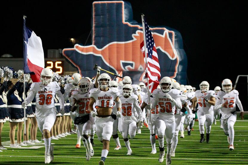 The Sachse football team enters the field before the start of a high school football game...