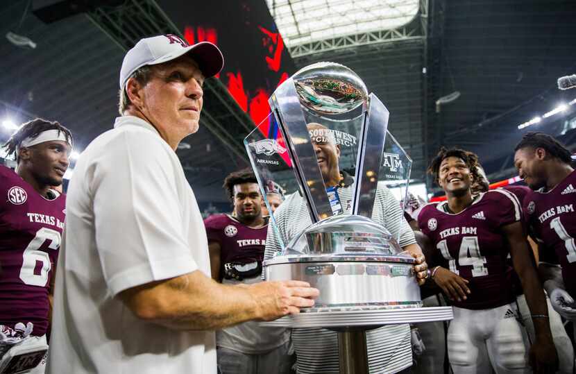 Texas A&M Aggies head coach Jimbo Fisher accepts the Southwest Classic trophy after a 24-17...