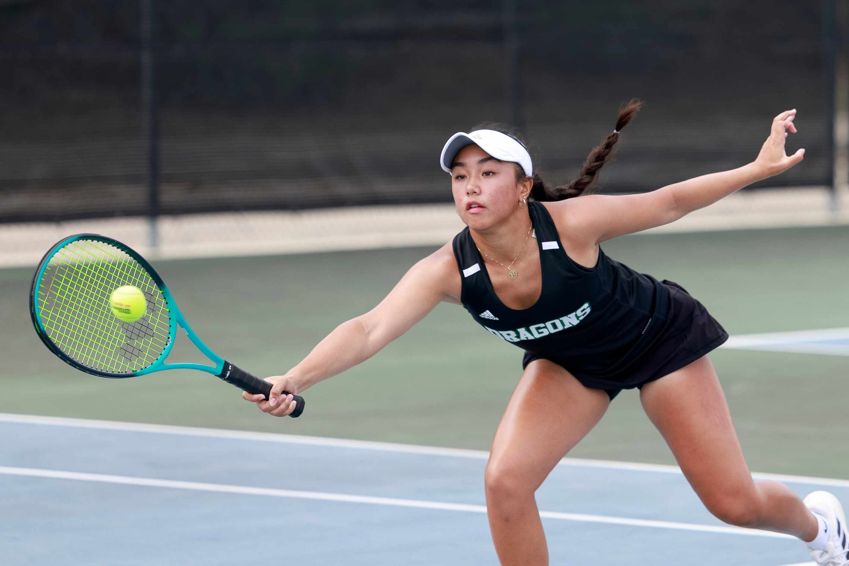 Southlake Carroll’s Rosabella Andrade stretches for a shot during the 6A girls doubles...