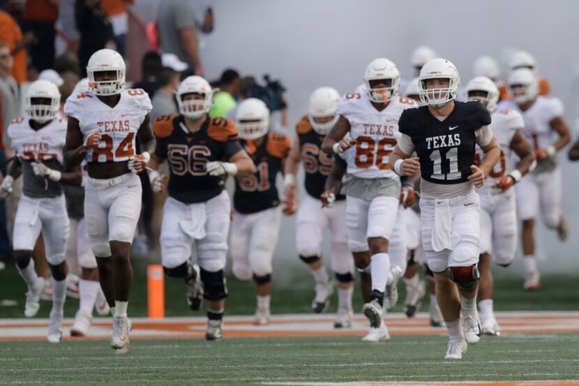 Texas quarterback Sam Ehlinger (11) leads the team on to the field during the team's...