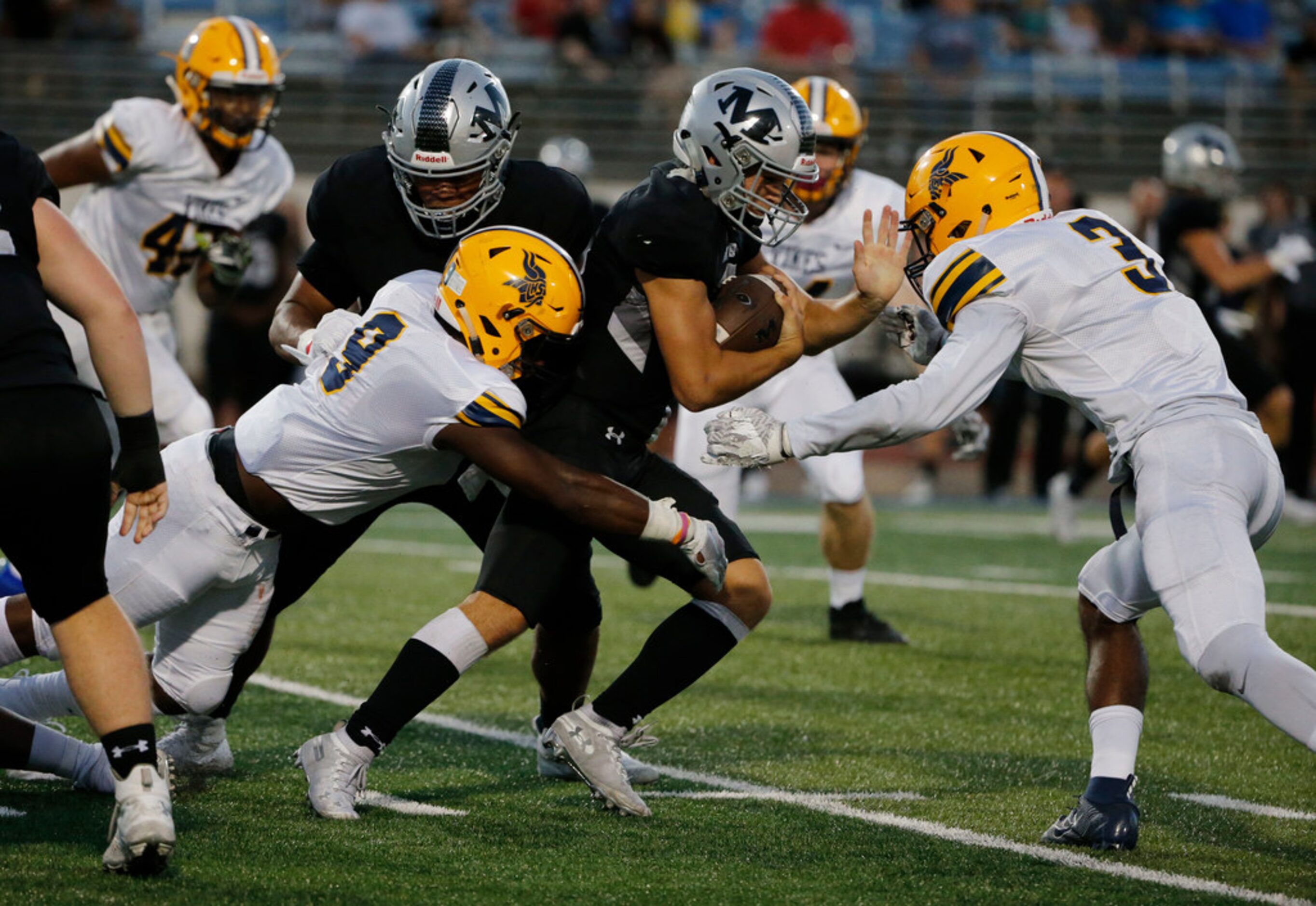 Arlington Lamar's Jayveion Moore (9) and James Douglas (3) attempt to tackle Arlington...