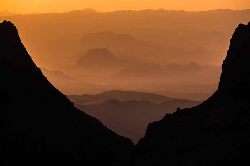 A brilliant sunset is seen through The Window at Chisos Basin in Big Bend National Park. 