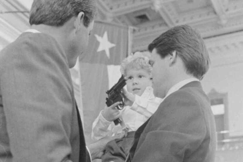 During a 1987 visit to the state Capitol, Griffin Perry played with a toy gun while his dad...