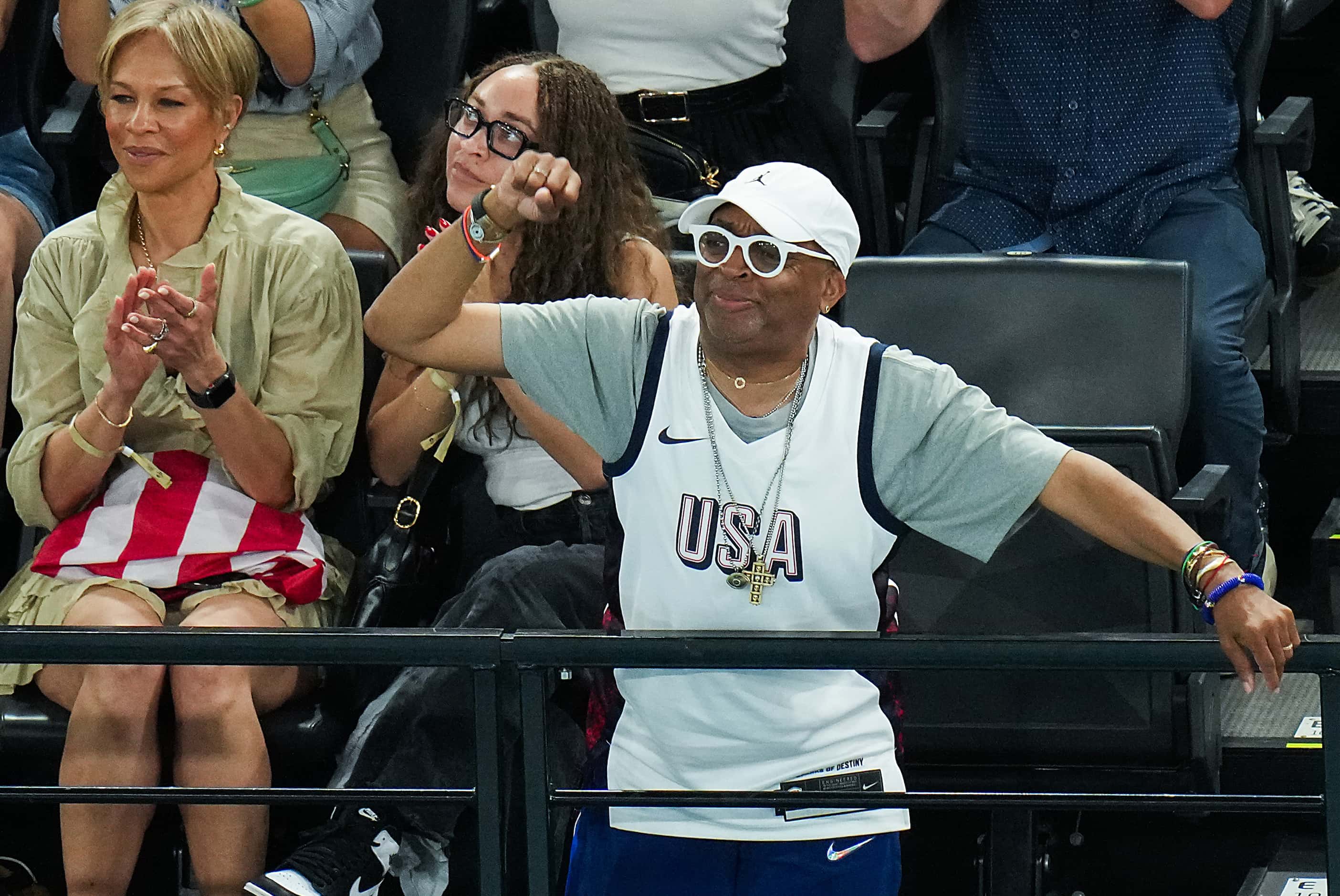 Film director Spike Lee cheers Simone Biles of the United States after she competed on the...