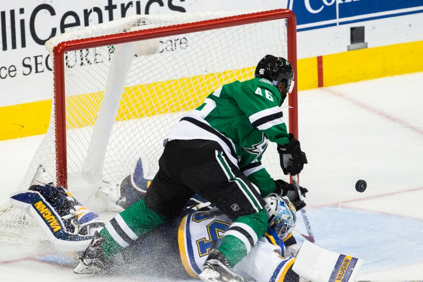 Dallas Stars center Gemel Smith (46) reaches for the puck over St. Louis Blues goalie Jake...