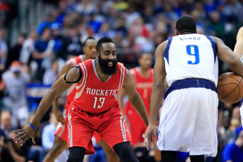 Feb 20, 2015; Dallas, TX, USA; Houston Rockets guard James Harden (13) laughs while guarding...