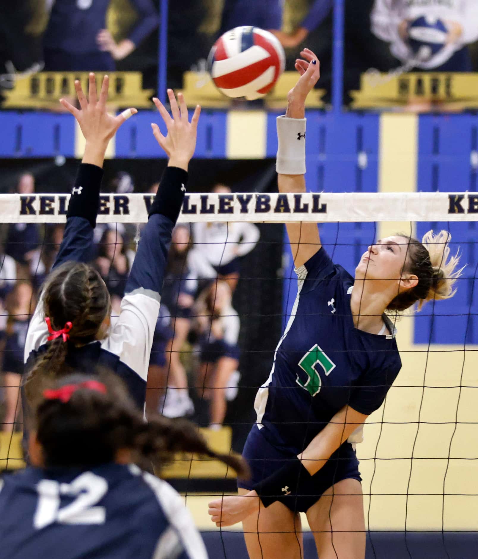 Eaton High’s Emily Simmons (5) spikes the ball past a Keller High defender during the second...