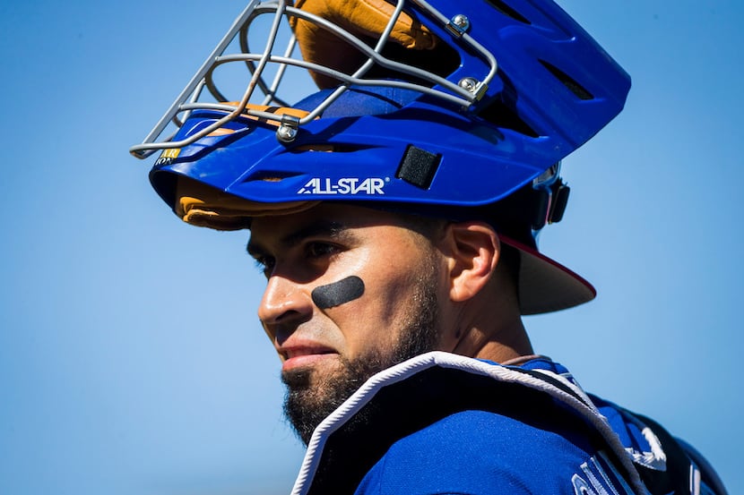 Texas Rangers catcher Robinson Chirinos looks to the dugout for a sign during the fourth...
