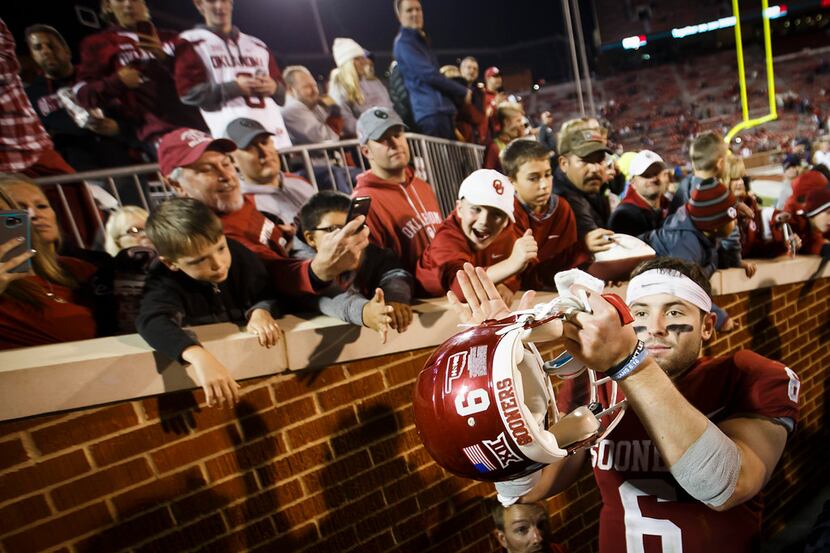 Oklahoma quarterback Baker Mayfield salutes the home crowd as he leaves the field after the...