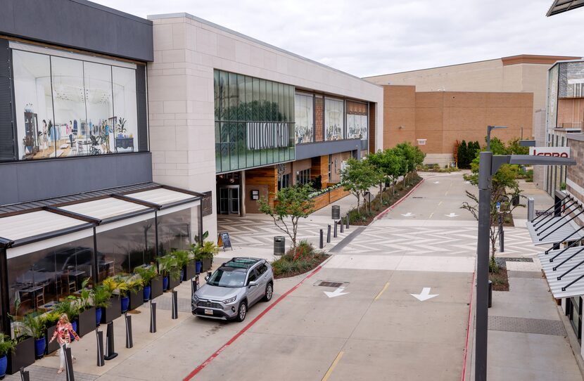 People move along the sidewalk of The Shops at Willow Bend in Plano on Thursday, April 27,...