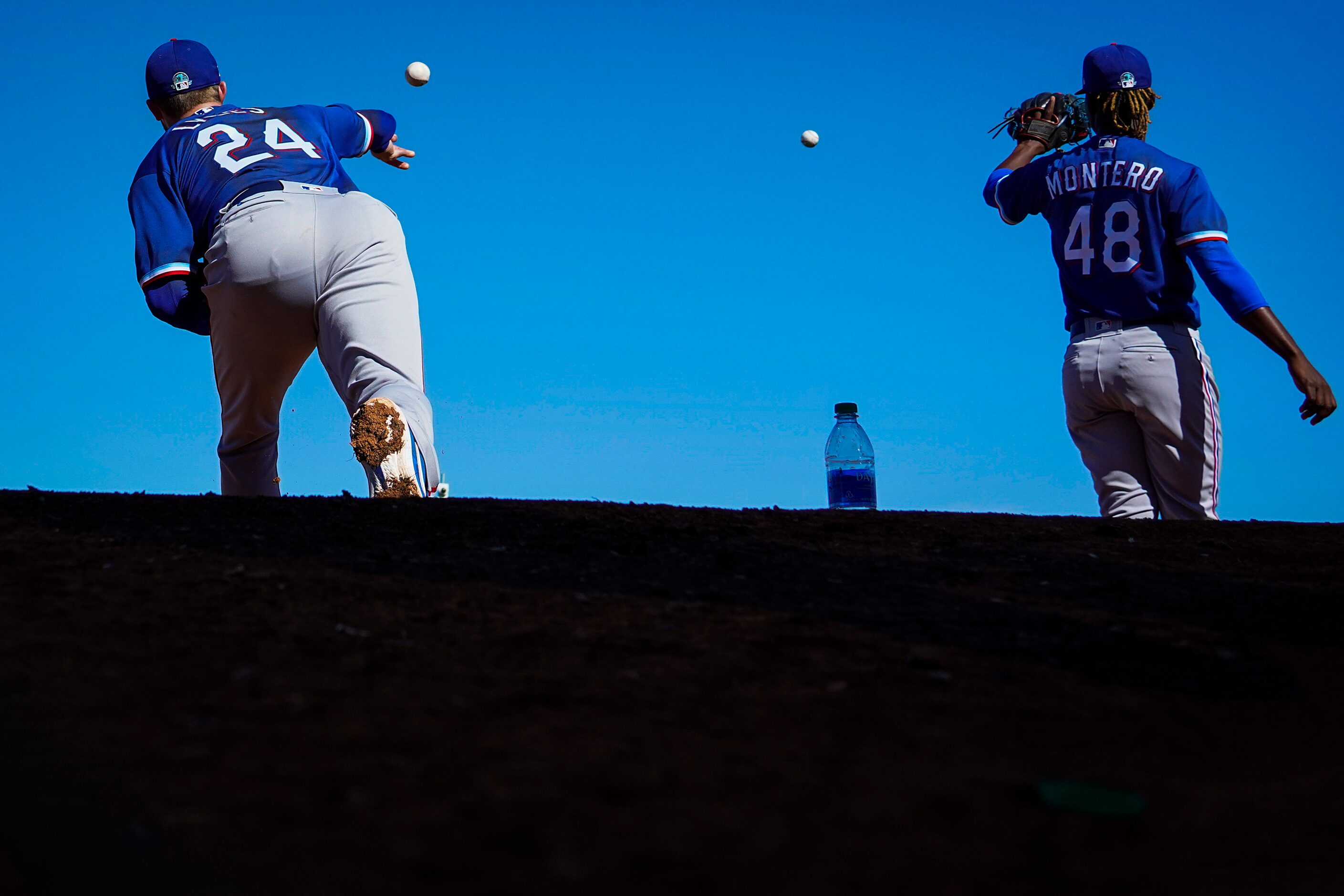 Texas Rangers pitchers Jordan Lyles (24) and Rafael Montero (48) work in the bullpen during...