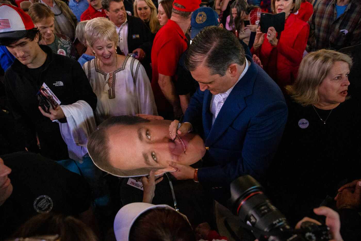 Senator Ted Cruz signs a cutout of his head following his campaign rally at The Fort Worth...