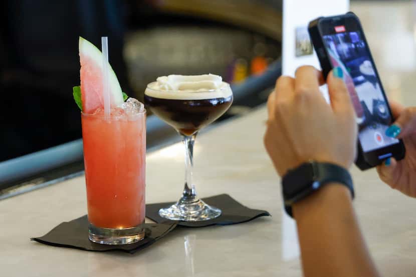 A patron takes a photo of the Shamar’s Passion and espresso martini cocktail at NINE Kitchen...