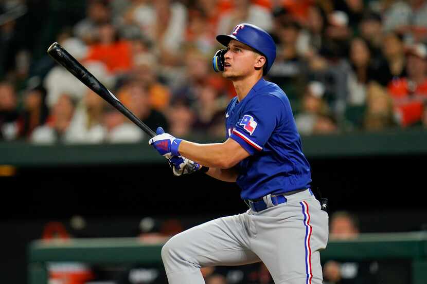 Texas Rangers' Corey Seager watches his ball as he flies out against the Baltimore Orioles...