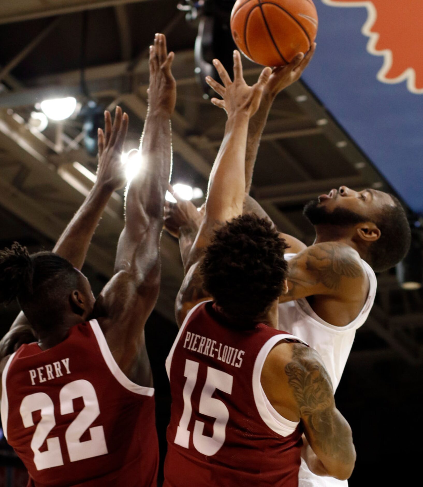 SMU guard Tyson Jolly (0) shoots over the defense of Temple defenders De'Vondre Perry (22)...