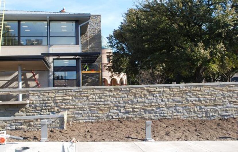 Construction crews work on the entryway of Dallas CASA’s new offices on Swiss Avenue. The...