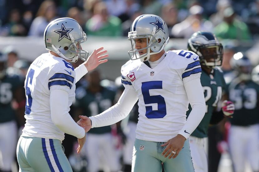 Dallas Cowboys punter Chris Jones (6) congratulates  kicker Dan Bailey (5) after he make a...