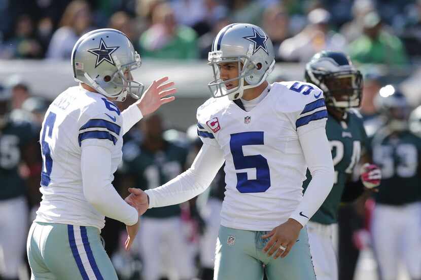 Dallas Cowboys punter Chris Jones (6) congratulates  kicker Dan Bailey (5) after he make a...