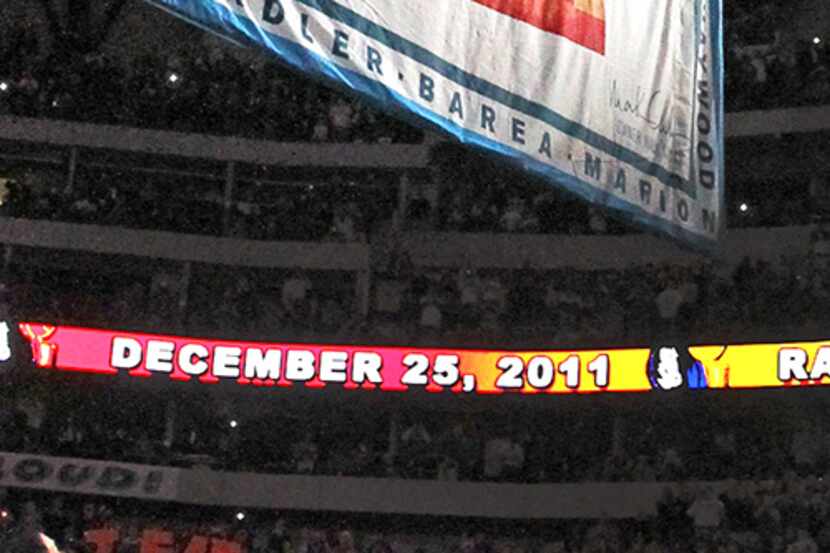  December 25, 2011--The Dallas Mavericks team gathers under the Championship banner as it is...