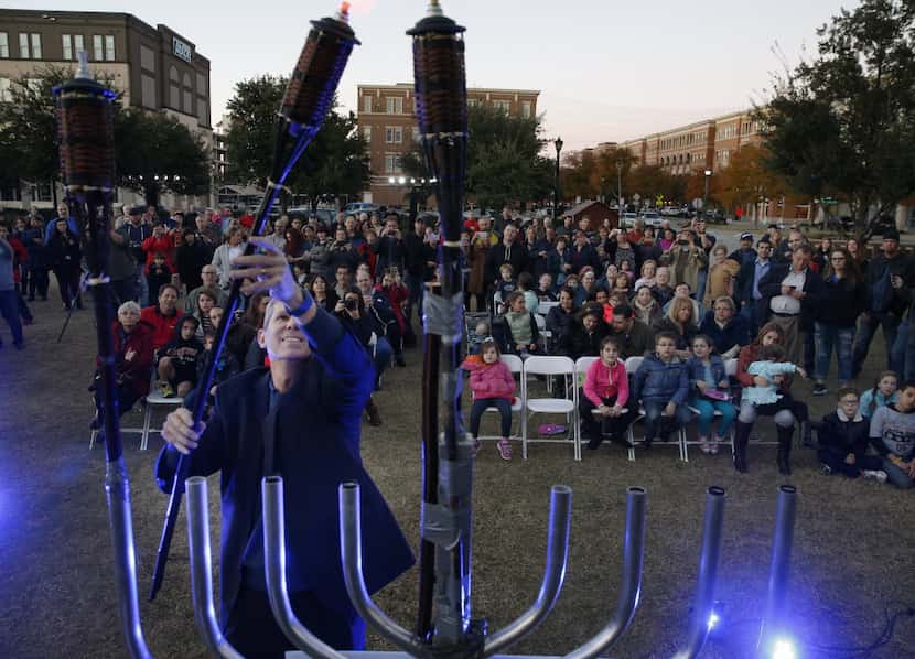 A menorah is lighted during a ceremony hosted by Chabad of Frisco at Frisco City Hall in...