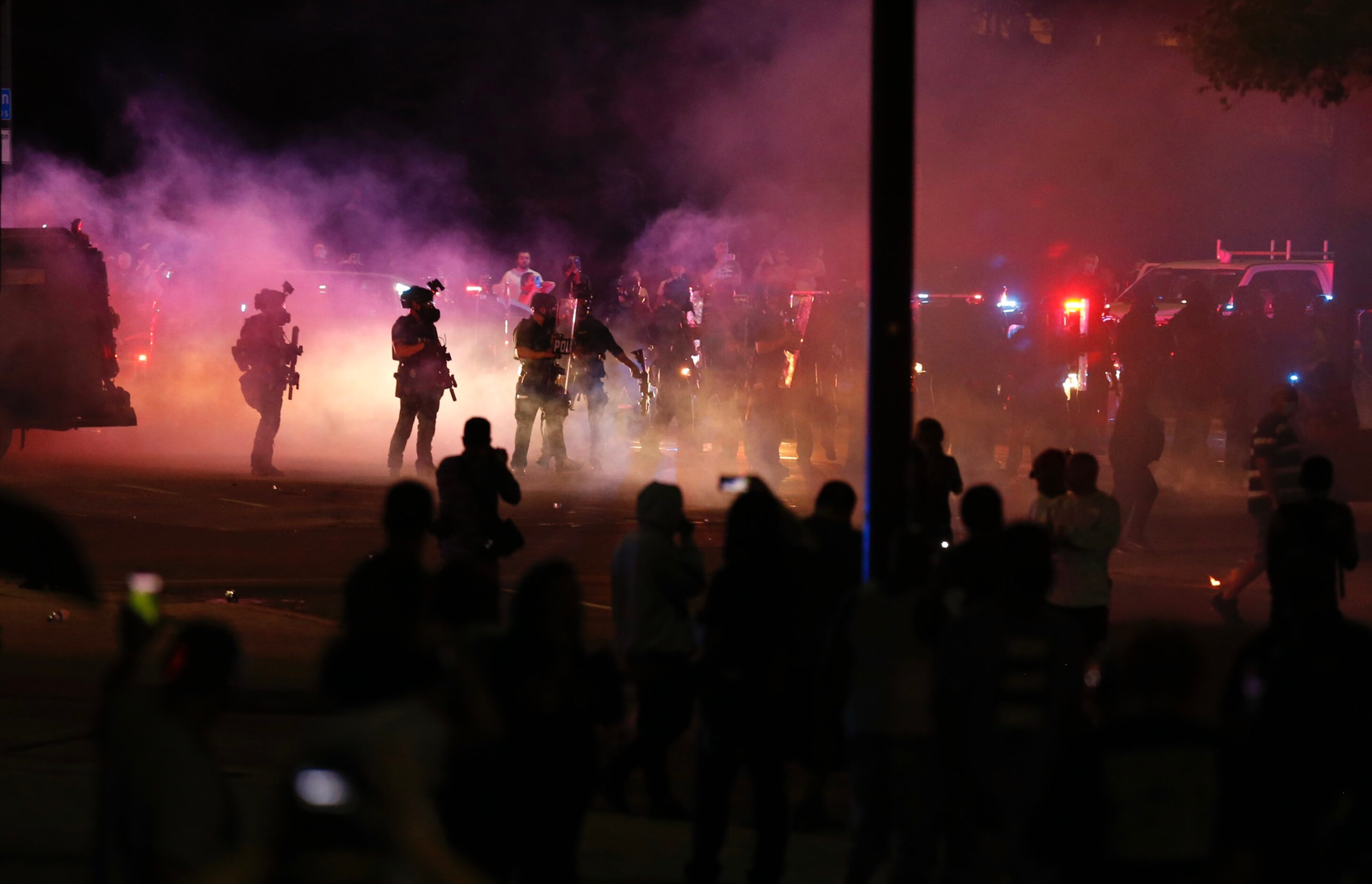 Protesters rally Friday during a demonstration against police brutality near downtown...