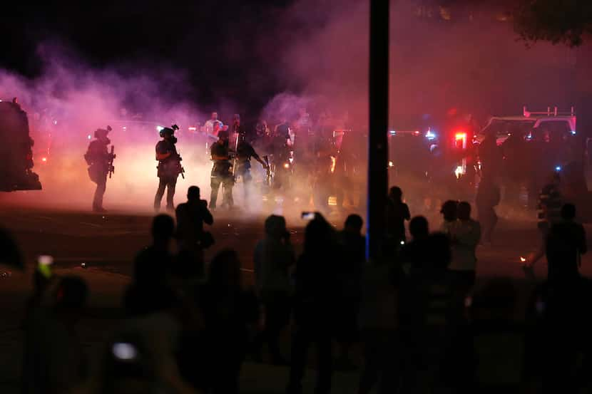 Protesters rally during a demonstration against police brutality in downtown Dallas on May...