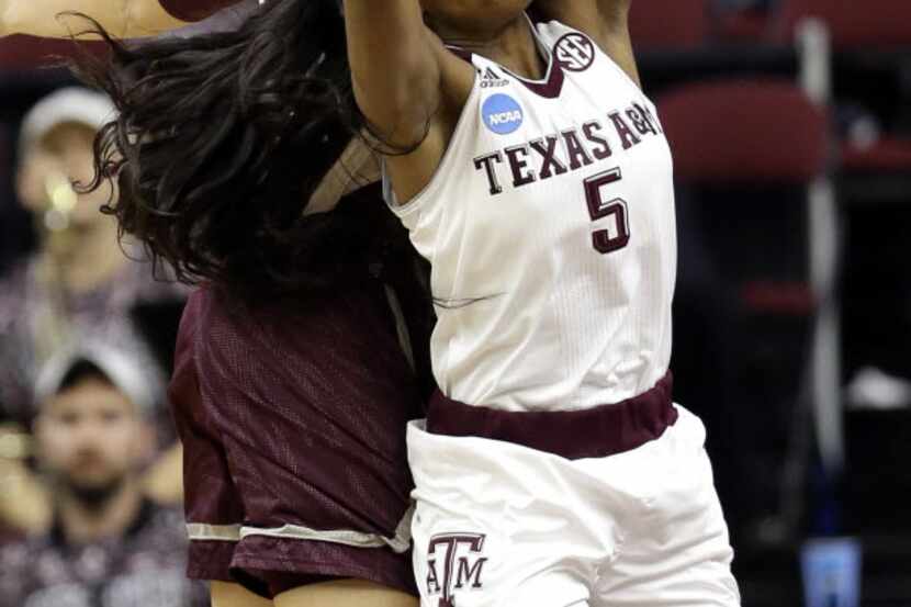 Anriel Howard (5) pulls down a rebound during her record-setting performance. The Aggies...