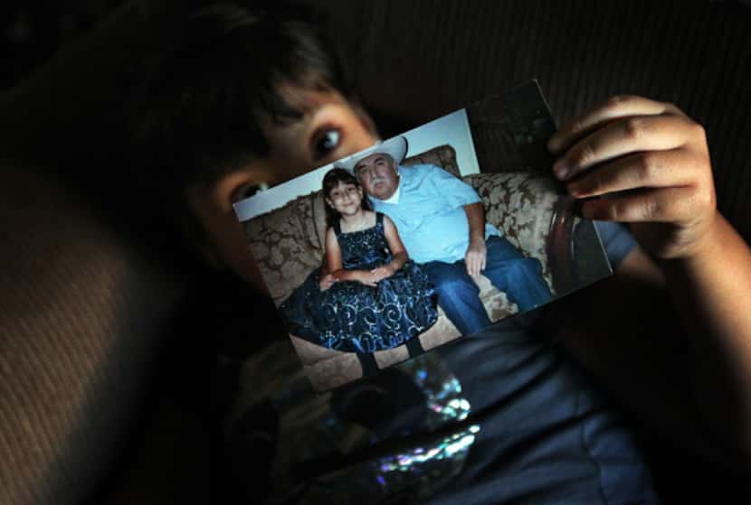 Mariana Saldivar holds a picture of her father, who used to drive her to every medical...