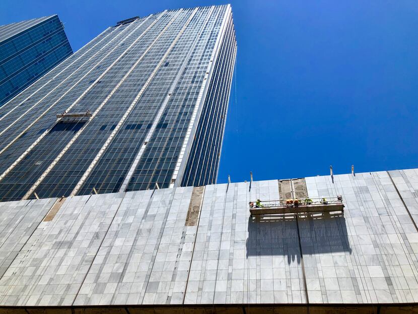 Construction workers are reinstalling the marble on the First National Bank buildings in...