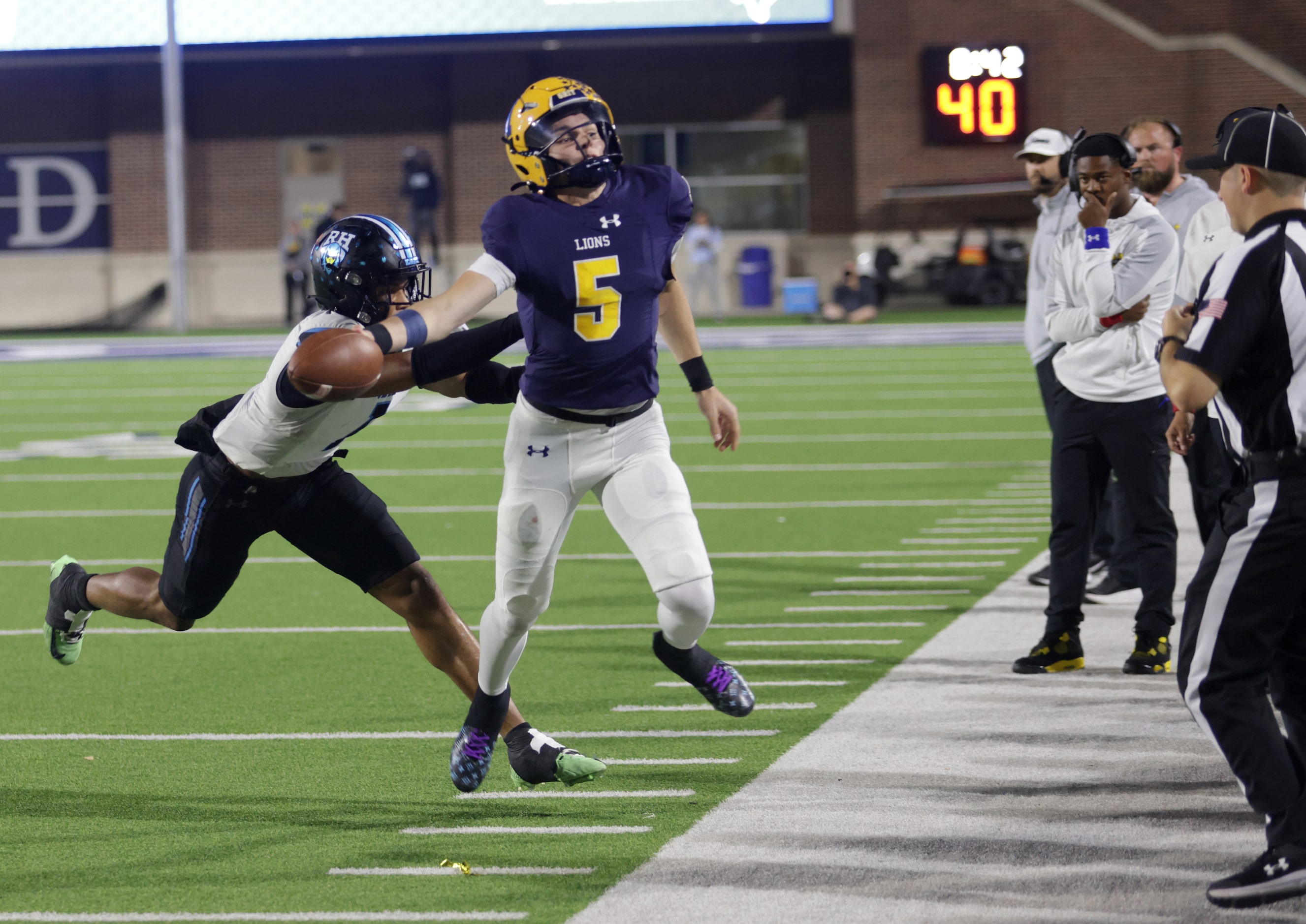 Rock Hill player #1 Jayden Bradley pushes McKinney player #5 Jeremiah Daoud out of bounds...