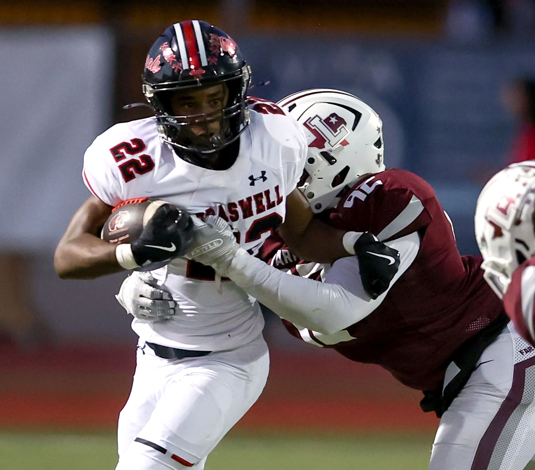 Denton Braswell running back Zahir Trufant (22) is brought down by Lewisville defensive...