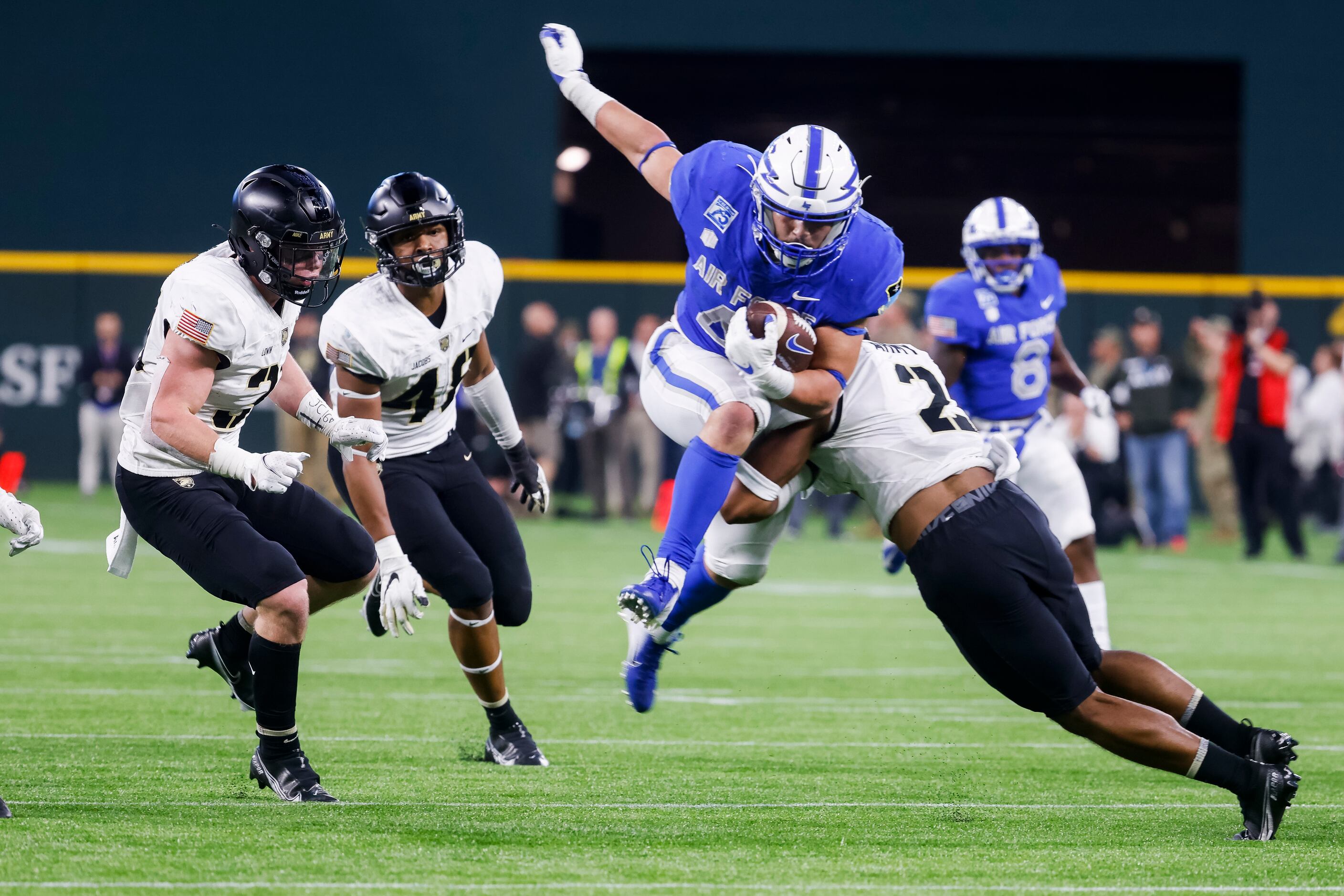 Air Force Falcons fullback Omar Fattah (44) tries to jump to avoid Army Black Knights...