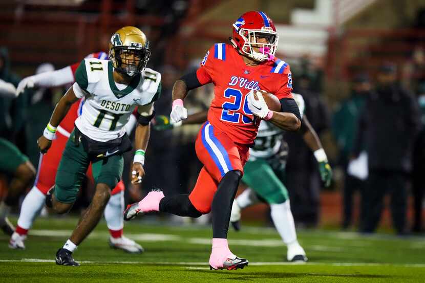 Duncanville running back Caden Durham (29) gets past DeSoto defensive back DeMichael Porter...