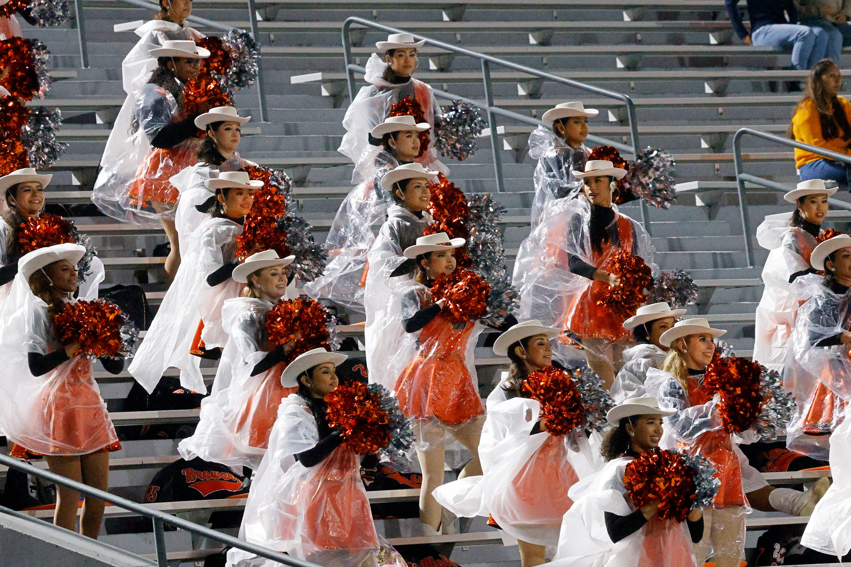 Haltom Highsteppers perform in the rain in the second half of a high school football game...