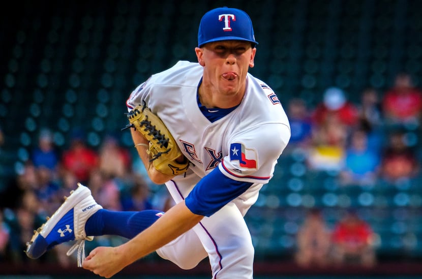 Texas Rangers pitcher Kolby Allard follows through on a pitch during the first inning...