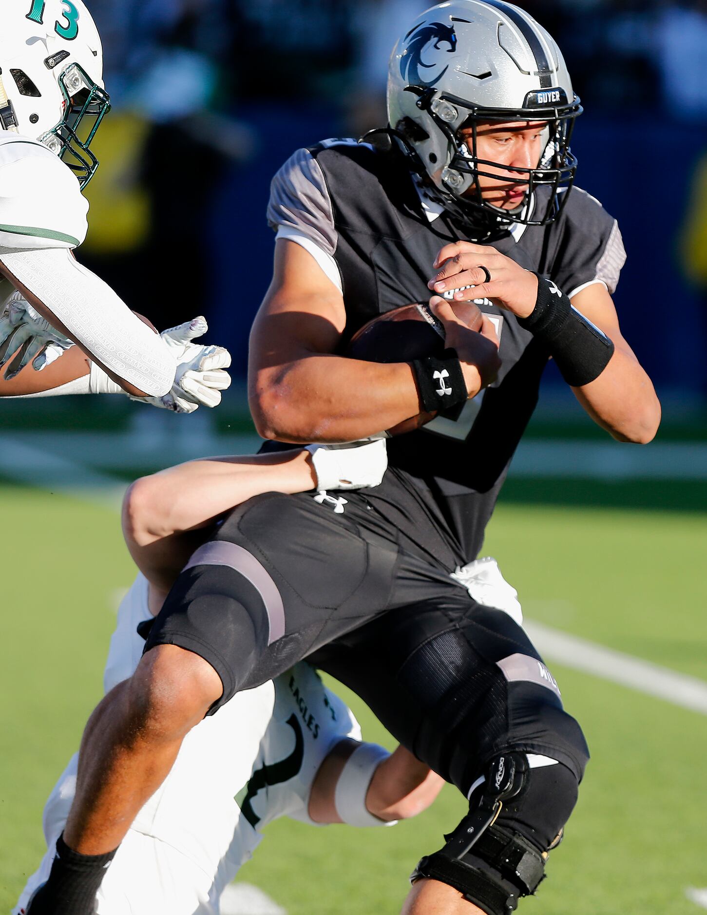 Denton Guyer High School quarterback Eli Stowers (3) is bright down by Prosper High School...