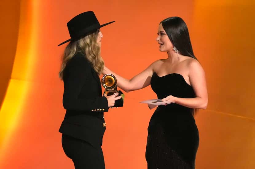 Kacey Musgraves, righgt, presents the award for best country album to Lainey Wilson for...