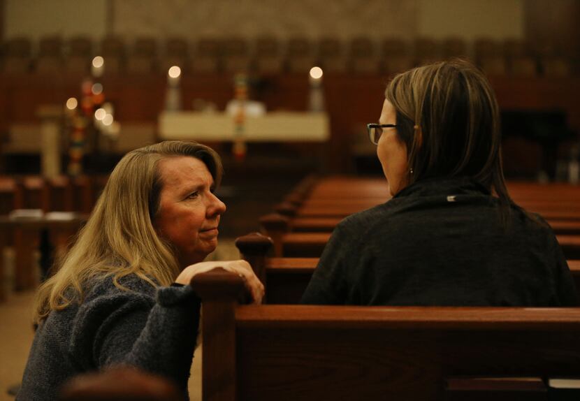 The Rev. Laura Echols-Richter (left) speaks with church member Tina McGarry in the sanctuary...