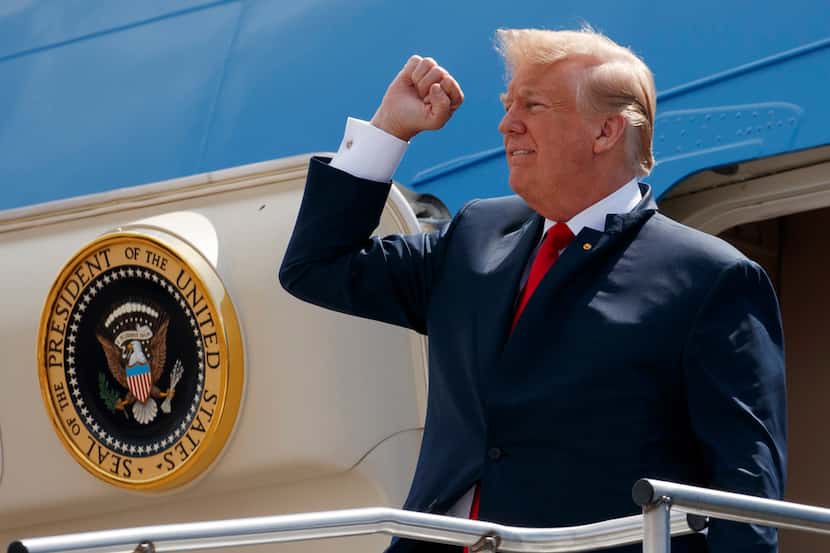 In this May 31, 2018 photo, President Donald Trump pumps his fist as he steps off Air Force...