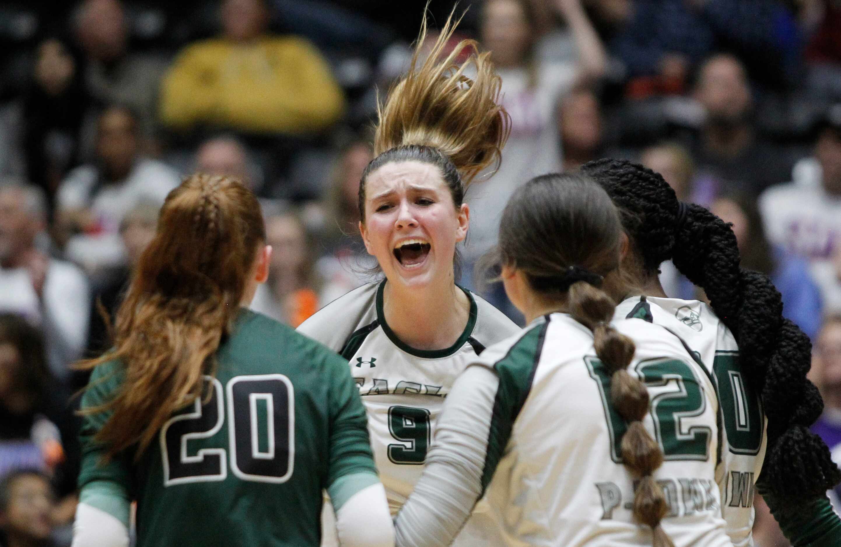Prosper senior Ayden Ames (9), center, lets out a yell while celebrating with teammates...