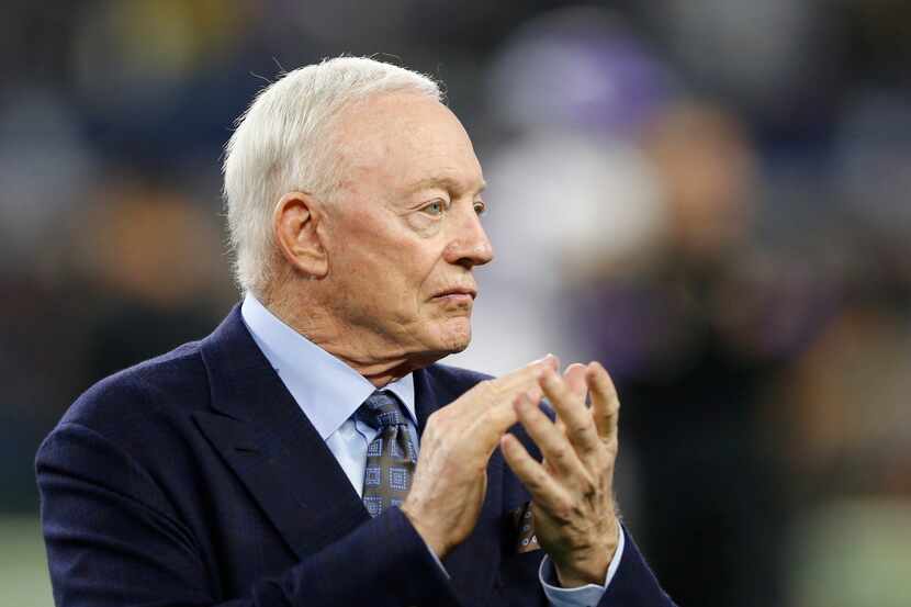 FILE - Cowboys owner Jerry Jones claps as the team takes the field for warmups before a game...